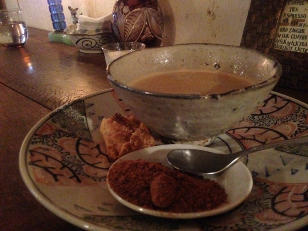 Bowl of black coffee from cafe antique with milk and sugar and cookie